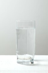 Transparent glass with water on a wooden table. Drinking clear water in the morning for health