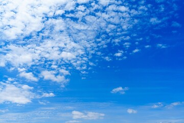 This stock photo features a stunning blue sky dotted with fluffy white clouds, perfect for...