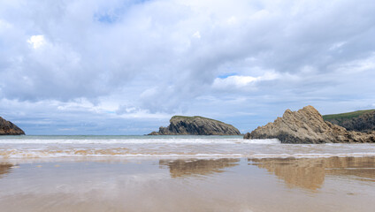 Beach with rock formation on the horizon. Limestone erosion