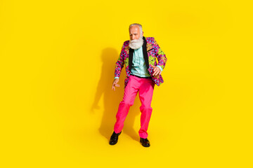Full size photo of handsome pensioner mister dancing enjoy party dressed stylish colorful pink classy garment isolated on yellow background