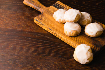 Homemade gingerbread cookies with honey and cinnamon with white sugar fondant, on a dark wooden...