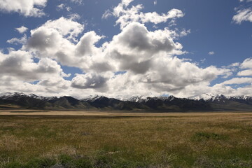 Mountains, meadows, and blue skies with clouds