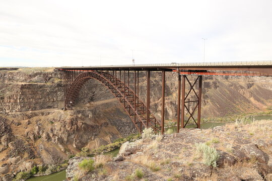 Rusted steel bridge crossing deep canyon