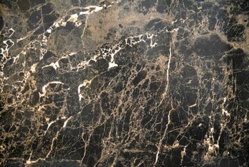 Fototapeta premium Dark beautiful marble texture showcasing brown veining and color contrasts