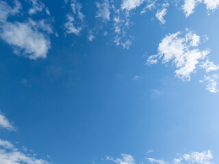 A bright blue sky with fluffy white clouds creates a serene atmosphere, perfect for relaxation and inspiration. Ideal for backgrounds or nature themes.