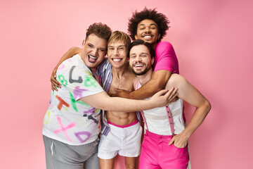 Four friends joyfully express their queer identity against a vibrant pink backdrop.