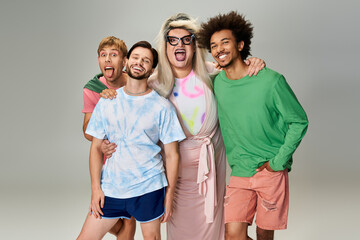 Four friends express their joy and pride in colorful outfits during a creative photoshoot.