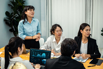 Diverse group of business analyst team analyzing financial data report paper on office table. Chart...