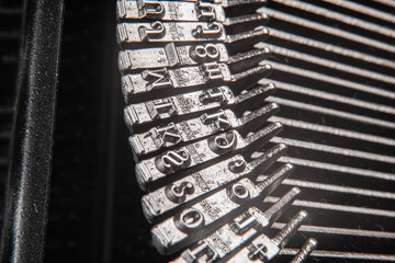 Close-Up View of Metal Typebars from a Vintage Typewriter Mechanism in a Macro Perspective
