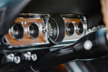 Close-Up View of Vintage Car Dashboard With Wood Paneling and Chrome Details