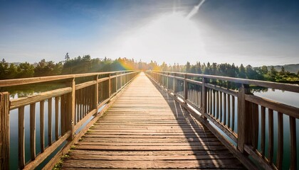 Obraz premium wooden bridge over a body of water the bridge is wooden and has a sun shining on it