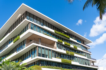 Obraz premium Architectural exterior detail. Residential house exterior fragment. Modern apartment building. Apartment building with balcony. View of building. Green design. Residential building architecture