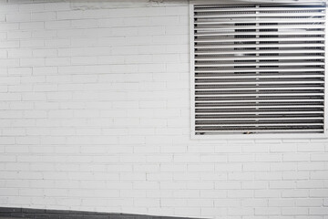 White Painted Brick Wall with Vent Grid Beside It in Minimalist Decor