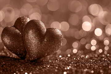 Fototapeta premium Two hearts on a background with romantic blurred bokeh. Valentine's Day.
