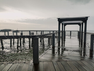 Beach view with cloudy weather on the edge of the pier. Bad weather concept at sea