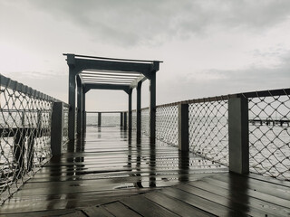 Beach view with cloudy weather on the edge of the pier. Bad weather concept at sea