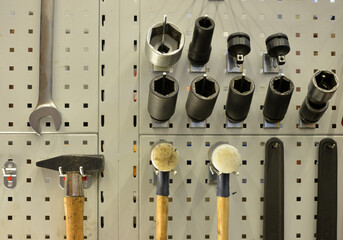 Screws, hammer, pliers, tools on a wall, tidy