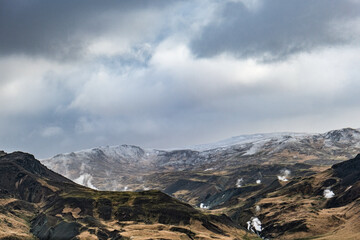 Mountain valley in Iceland with steam and snow