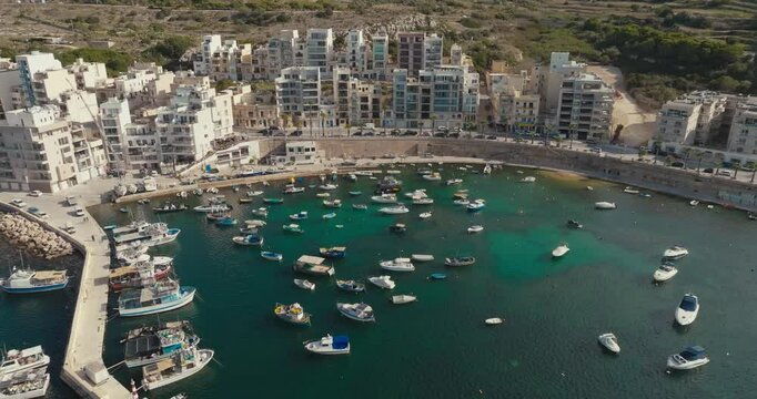 Aerial View of Marina in Bugibba Malta Showing Scenic Cityscape of Tourist Destination on the Mediterranean with Yachts and Boats Along the Embankment. High quality 4k footage