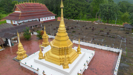 Golden Pagoda Temple Complex: Aerial view of a stunning golden pagoda, surrounded by traditional...