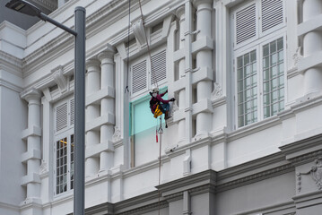 Acrobatic Mayson At Work Harnessed On A Building