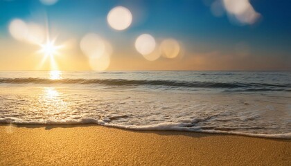 Obraz premium tropical beach scene featuring soft golden sand and bokeh sunlight reflecting on gentle waves perfect for overlaying custom text or graphics