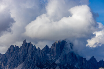 Above the clouds mountain landscape in the Dolomiti Alps, Italy. Rocky prominent towering peaks...