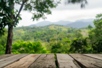 Fototapeta premium Wooden table with a view of mountains in the background. The table is empty. The view is blurry