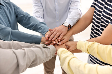 Fototapeta premium Teamwork. Group of employees joining hands in office, closeup