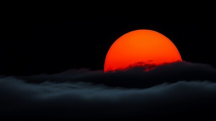 Obraz premium Fiery sunset orb above dark clouds.