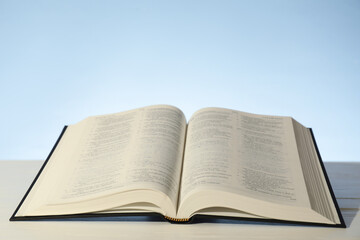 Open Holy Bible in English language on white table. Space for text