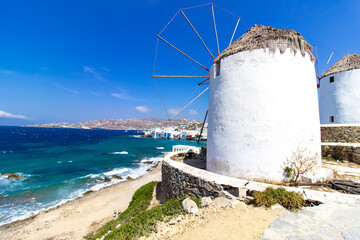 Traditional Greek windmills on Mykonos island under cloudy sky. Aerial view of iconic Mykonos...