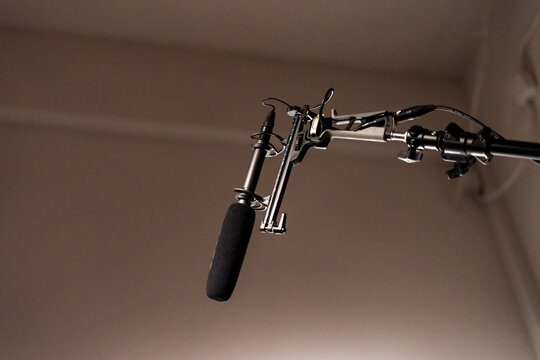 Boom Microphone for sound recording in film industry. Boom mic holds up high by video or film production