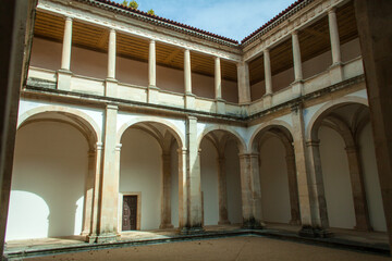 Fototapeta premium a peaceful cloister courtyard with a series of stone arches supported by elegant columns