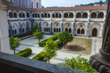 Fototapeta premium architectural grandeur of a historic monastery with its ornate facade, intricate details, and a lush green courtyard
