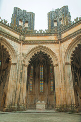 Fototapeta premium dramatic interior view of a historic chapel with towering stone arches, stained glass windows, and intricate architectural details, creating a sense of awe and reverence
