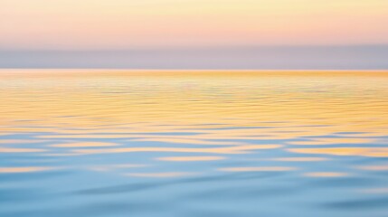 Fototapeta premium Soft pastel sunset reflecting on calm ocean water.