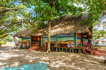 A beach hut with a colorful mural on the wall