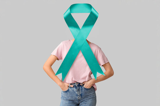 Young woman in blank t-shirt on grey background