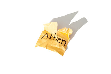 German word "Aktien" on a crumpled paper