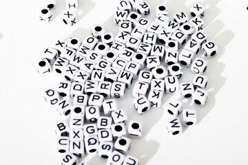 small dice with letters on a white background