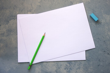 Blank paper on grey background, pencil and eraser