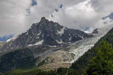 Obraz premium Aiguille du Midi peak in the Alps. Chamonix valley landscape of a prominent rocky towering mountain peak in french Alps. Chamonix-Montblanc area beautiful landscape of Aiguille du Midi summit