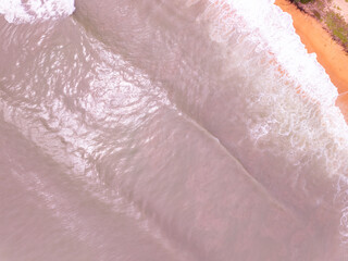 Amazing Top view colorful pink sand beach landscape background,Summer sea waves crashing on sandy shore seascape background,High angle view ocean nature beach background