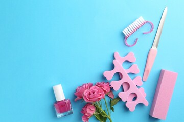 Set of pedicure tools on light blue background, flat lay. Space for text