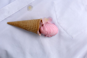 Iice cream with waffle cone on a white shirt, dirty stain