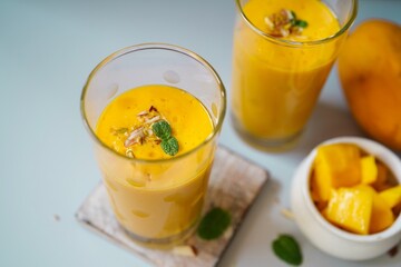 Fototapeta premium Homemade Mango Lassi | Traditional Indian smoothie with mangoes, selective focus