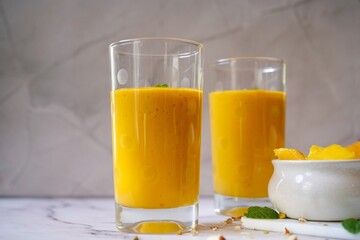 Fototapeta premium Homemade Mango Lassi | Traditional Indian smoothie with mangoes, selective focus
