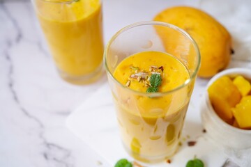 Homemade Mango Lassi | Traditional Indian smoothie with mangoes, selective focus