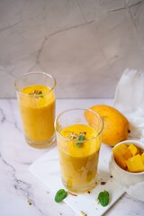Homemade Mango Lassi | Traditional Indian smoothie with mangoes, selective focus